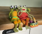 Handmade wool needle felted Mr Frog and Mrs Frog with long arms and legs in a knitted summer dress