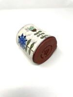 Handmade ceramic pottery mug with floral motives and handle with a metallic shine