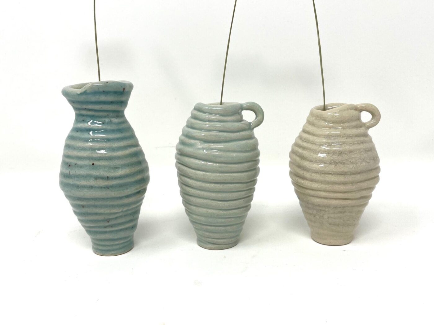 Coiled Mini Vase Trio (Bone, Blue, Teal) — in use
