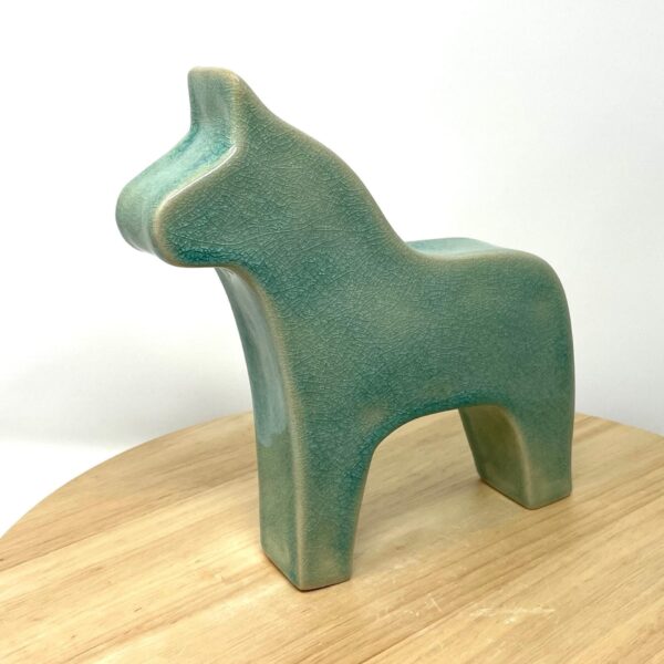Handmade Swedish Dala horse in white clay with turquoise crackle glaze