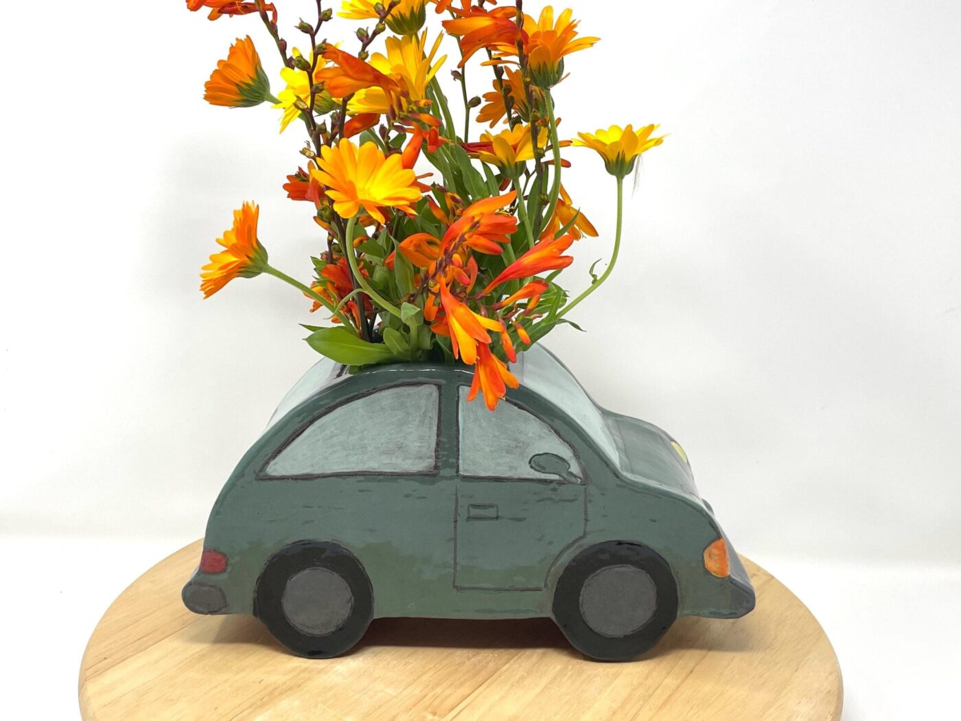 Dark Teal Ceramic Car Vase with Floral Roof — close-up