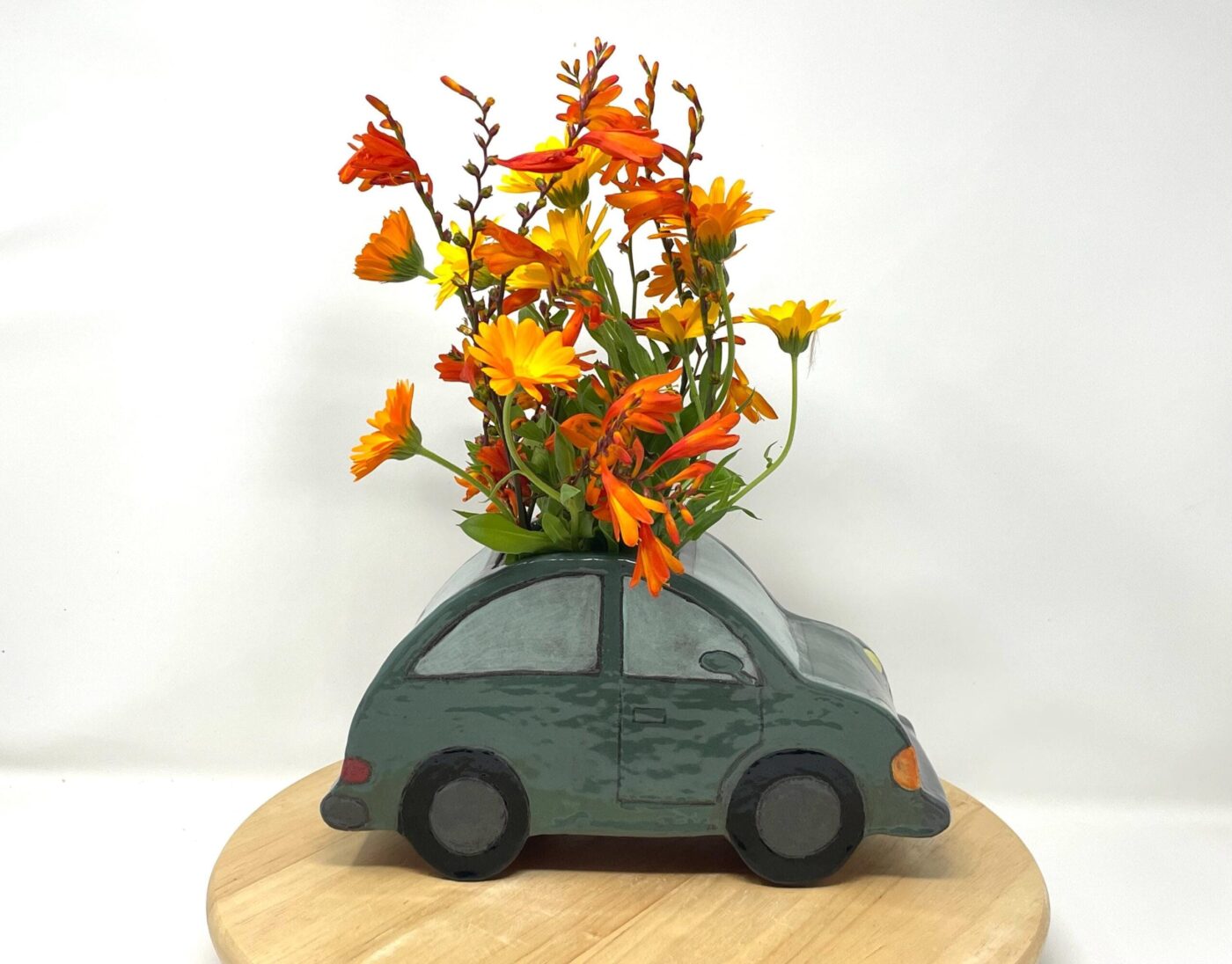 Dark Teal Ceramic Car Vase with Floral Roof — side view