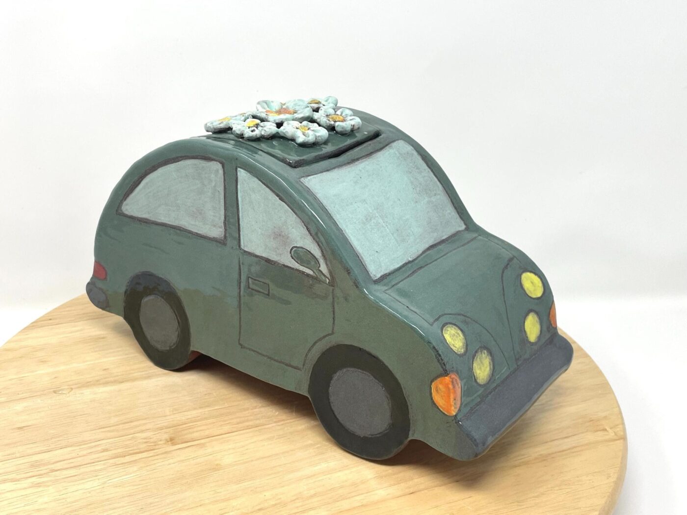 Dark Teal Ceramic Car Vase with Floral Roof — in use