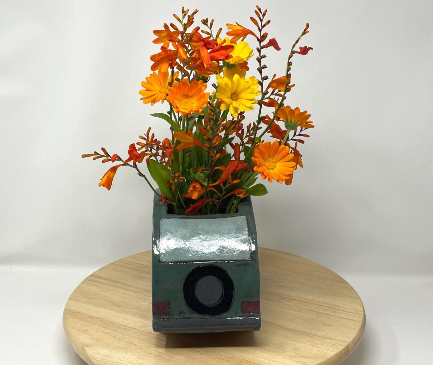 Dark Teal Ceramic Car Vase with Floral Roof — top view