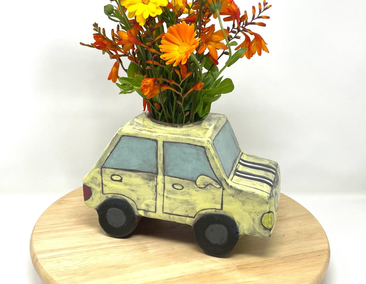 Pale Yellow Ceramic Car Vase with Floral Roof — side view