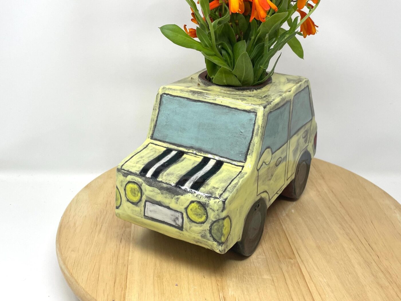 Pale Yellow Ceramic Car Vase with Floral Roof — close-up