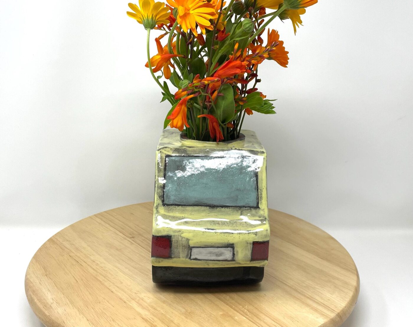 Pale Yellow Ceramic Car Vase with Floral Roof — top view