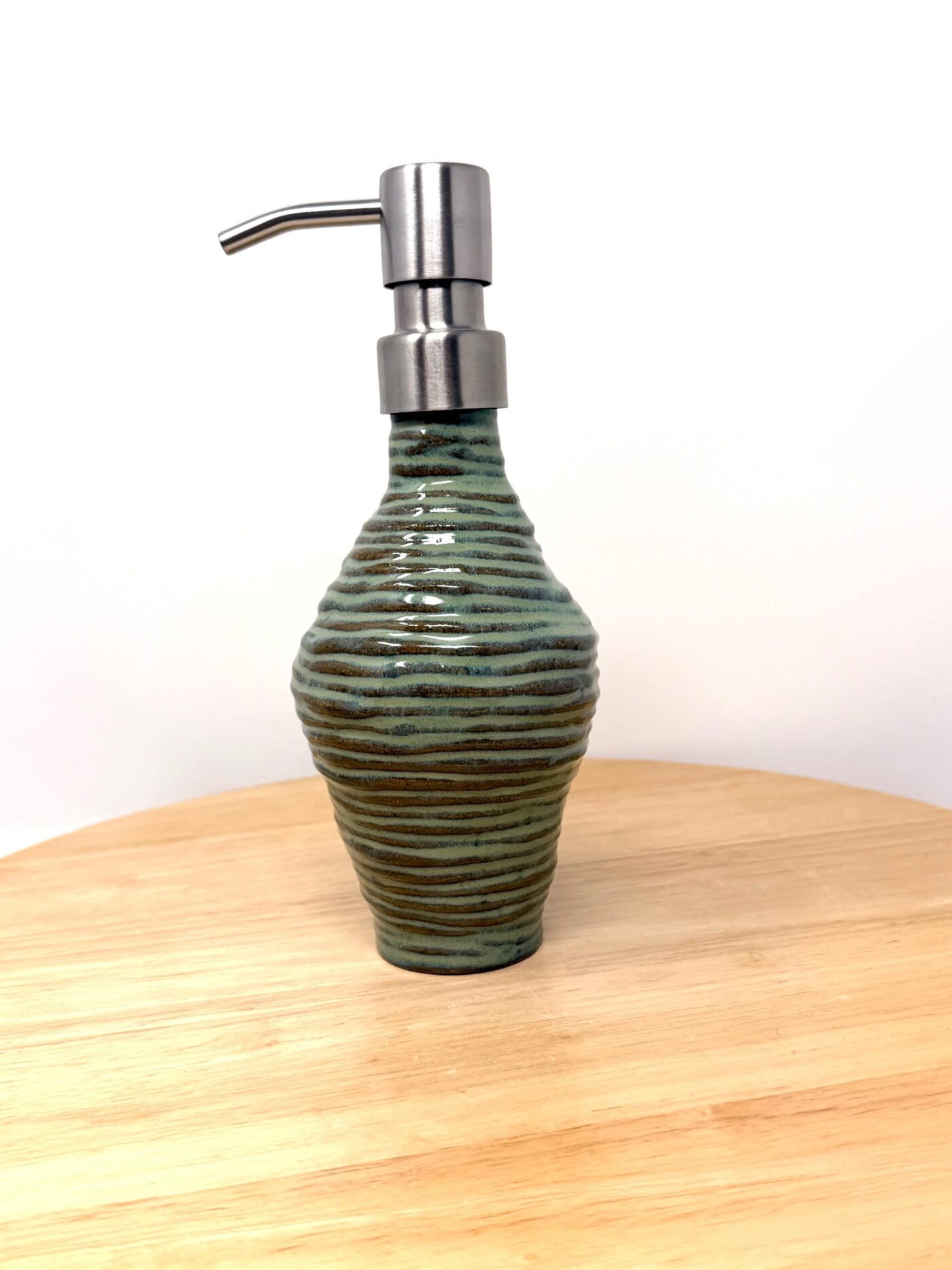 Handmade Turquoise Ceramic Soap Dispenser | Artisanal Coiled Clay | 250ml Capacity | Modern Stainless Steel Pump — in use