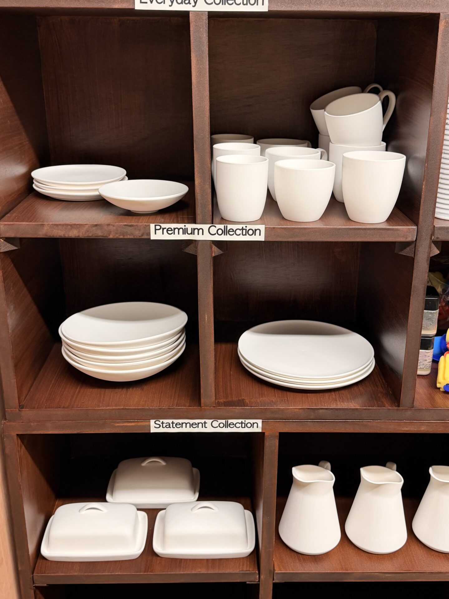 Pottery shelves showing Everyday, Premium and Statement collections