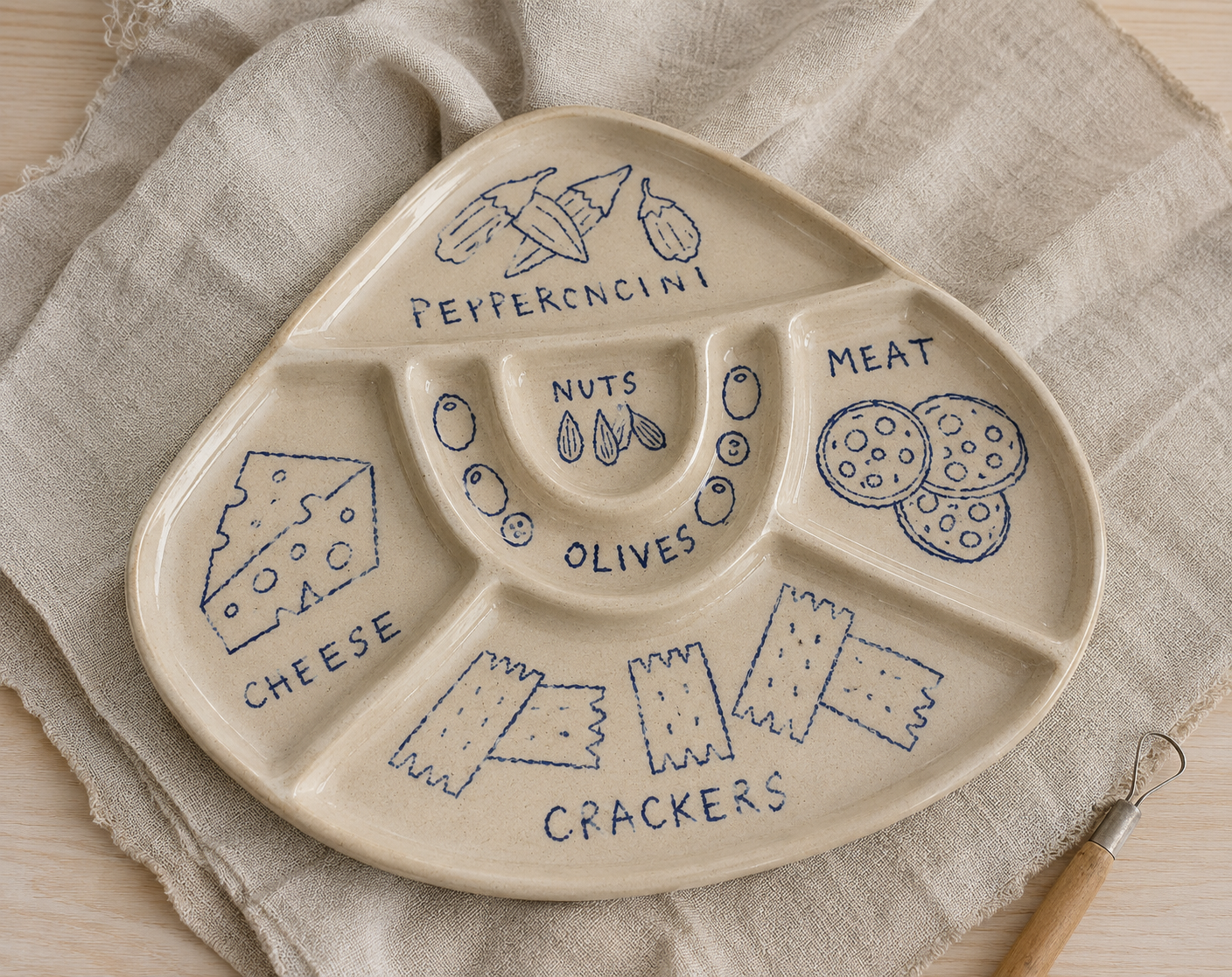 Ceramic snack tray with divided sections and blue food illustrations