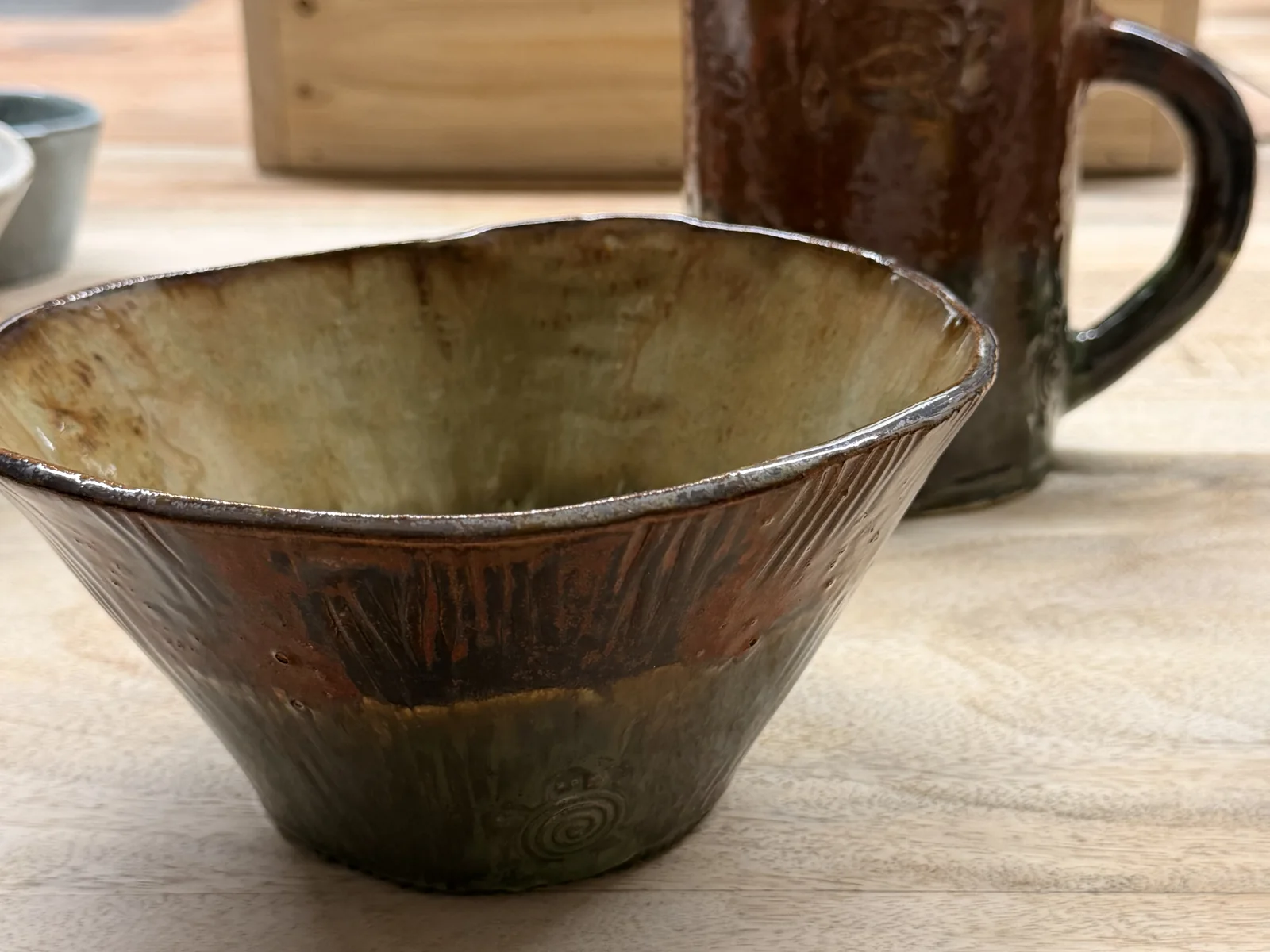 Earthy brown glazed mug and bowl made by a Fabode workshop guest