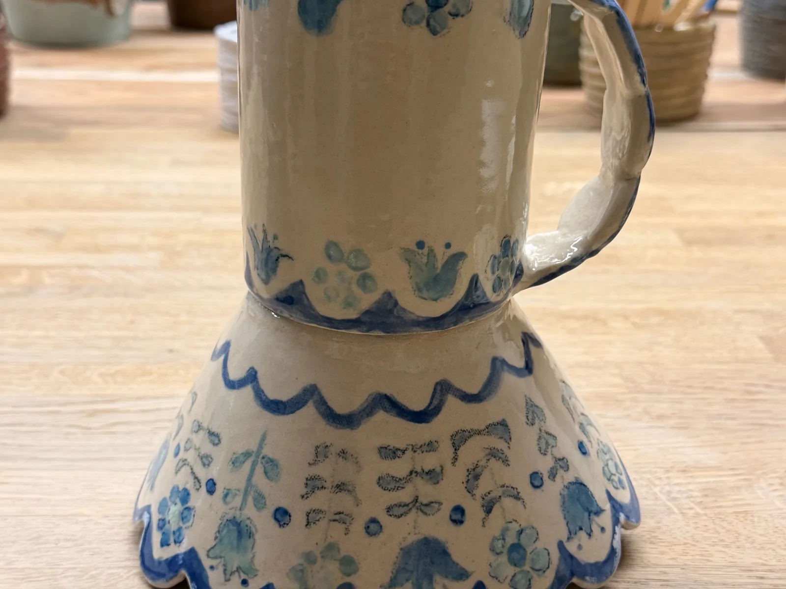 Blue floral mug and scalloped bowl after glazing and firing